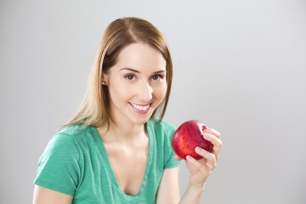 Woman Holding an Apple, Symbolizing Health.